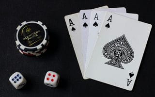 Cards, Dice, and Poker Chips on Black Surface