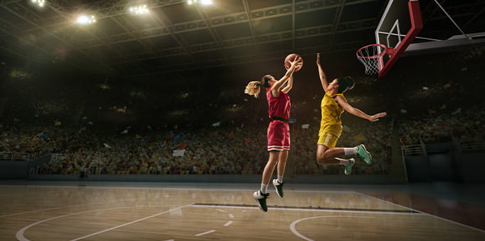 A young woman playing basketball.