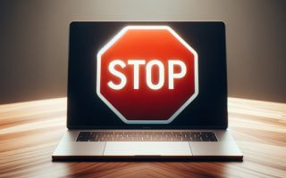 An image of a 'stop' sign in front of a laptop screen