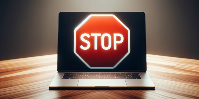 An image of a 'stop' sign in front of a laptop screen 