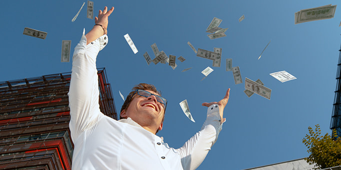 A picture of a man throwing money into the air