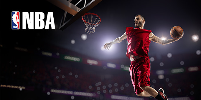 An NBA player scoring with a rebound