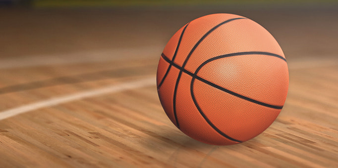 A close-up shot of a basketball placed on the court