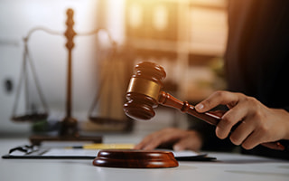 A judge holding a gavel in a court room