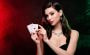 A woman displaying a hand of poker cards, portraying the main character of Molly's Game.