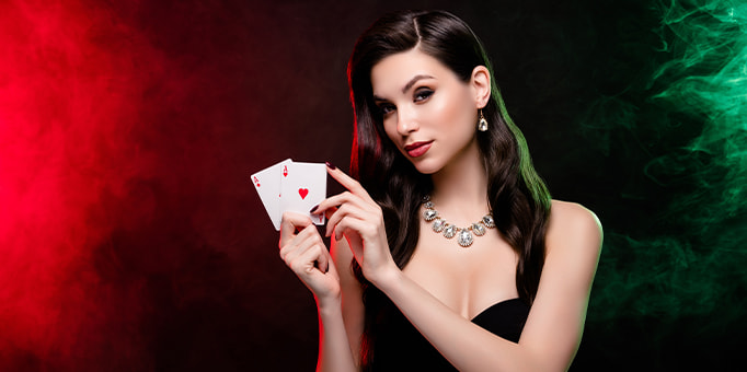 A woman displaying a hand of poker cards, portraying the main character of Molly's Game.
