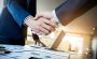 Two people shaking hands and making a deal