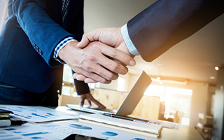 Two people shaking hands and making a deal