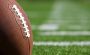 Two footballs on a field