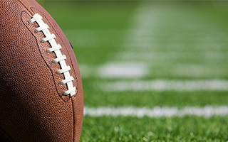 Two footballs on a field