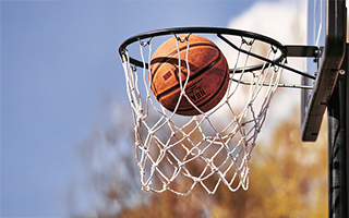 A basketball ball going inside a net
