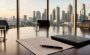 Boardroom table with an agreement and pen overlooking the Manila skyline